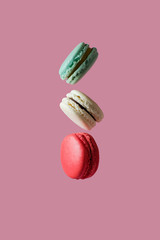 Beautiful colorful desserts. french macaroons on a pink background