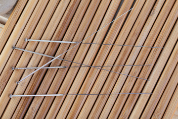 Table with needles for acupuncture. Silver needles for traditional acupuncture medicine on table.