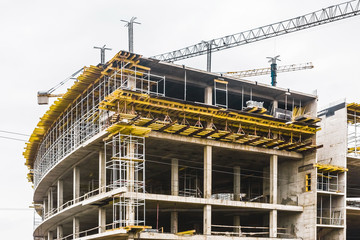 Unfinished new modern urban building at a construction site
