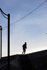 Running silhouette in the city at the morning