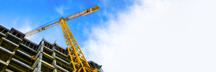 construction site and yellow crane on the background blue sky, panoramic mock-up