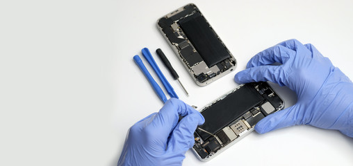 Technician repairing the Cell phone parts and tools for recovery repair smartphone and upgrade...