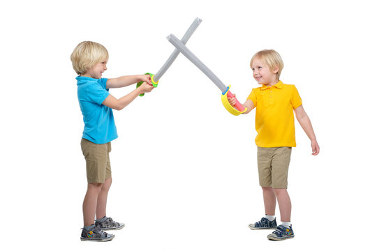 Two boys fencing isolated in studio on whit