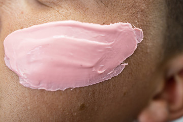 Male face waxing. The barber removes the hair on the man's face. Close up