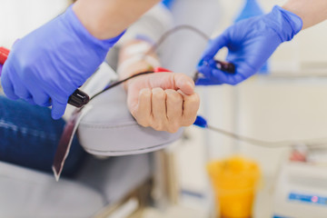 laboratory blood is removed during donation. hand close-up.
