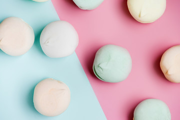 Colored sweet dessert zephyr marshmallows on pink & blue background. Air marshmallows. Close up, foo? photography