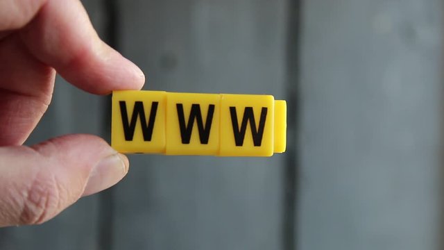 Web and www concept. Hand holds a sign with the inscription.