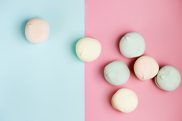 Gentle zephyr. close up. Air marshmallows in pastel shades on sky blue and pink background. Flat lay composition.