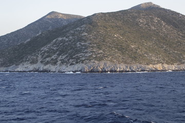 The waves beat against the impregnable shore of the island towering above the sea, the hills...