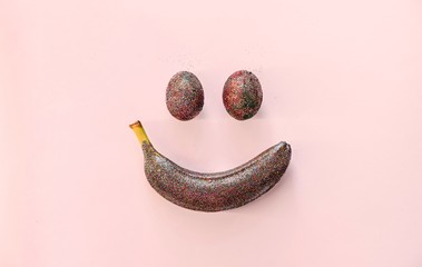 Banana and eggs on pink background