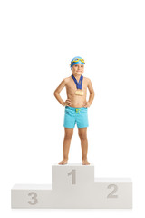 Child swimmer champion standing on a winners podium with gold medals