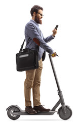 Man riding an electric scooter and looking at his mobile phone