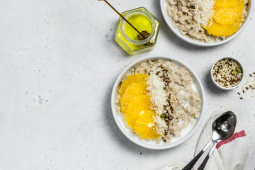 Vegan citrus coconut oatmeal. Top view, copy space.