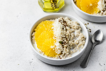 Breakfast bowls, coconut citrus oatmeal. Selective focus, copy space.