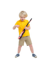 Boy plays on toy guitar isolated on white