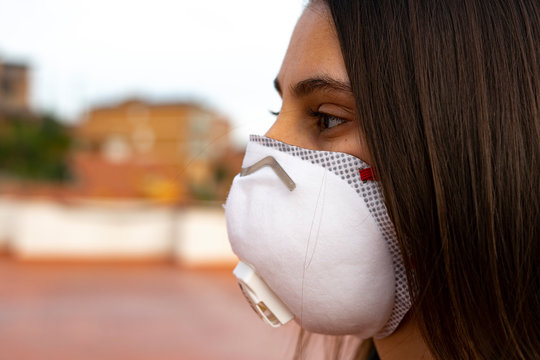 Woman with a doctor mask in the city. Virus Protection.