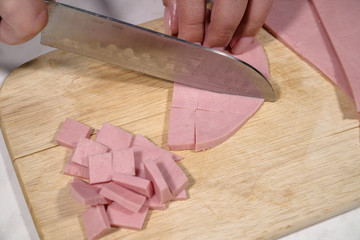 Knife sausage on a wooden stand on a table
