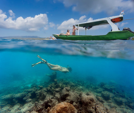 Young women have a fun in ocean, underwater view