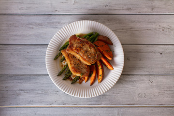 Honey garlic pork chops with asparagus and sweet potatoes. View from above, top view