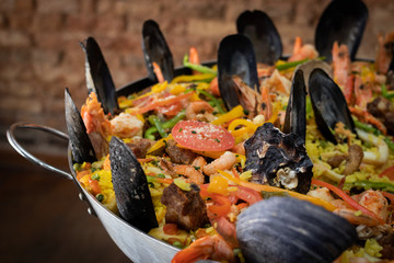 Clouse up on paella inside pan with sea swipes showing shrimp