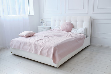 a large double bed in a bright room