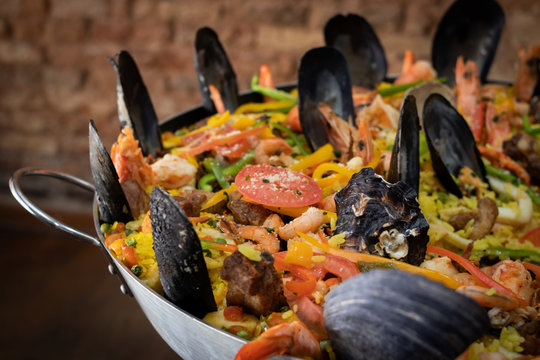 Clouse up on paella inside pan with sea swipes showing shrimp