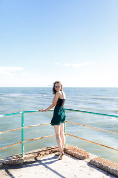 young girl in dress enjoying a vacation near the summer sea of Italy