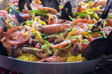 Close up photo of  shrimp, seafood paella inside pot pan.