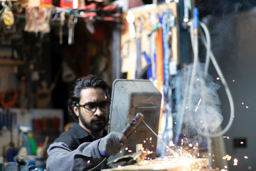 young welder technician working in workshop