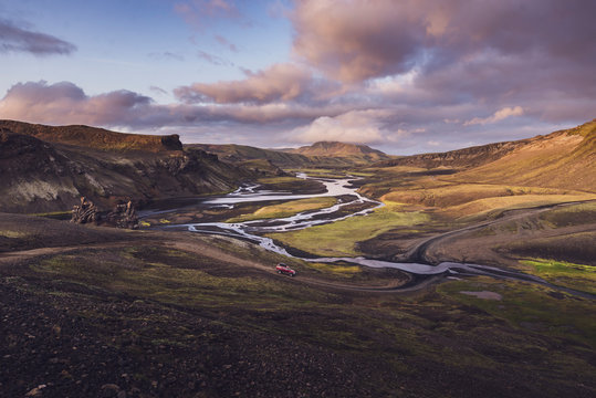 View of 4x4 about to cross river in wild valley in highlands Iceland