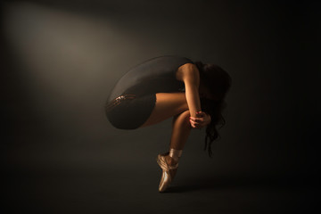 Dancer. Young elegant ballet dancer, dressed in black jersey, shoes an