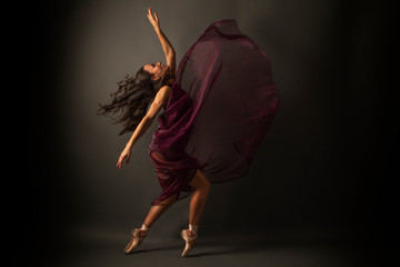 Graceful ballet dancer or classic ballerina dancing isolated