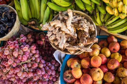 Overhead view of fruit and ginger at market.