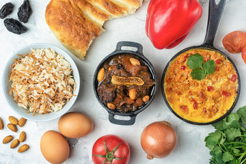 National cuisine of Turkey. Flatlay. Turkish omelet, Menemen, Kuzu mutancana and pilaf. There are a lot of ingredients around