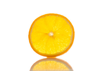 one slice of fresh orange on a white background with a reflection