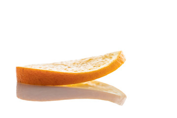 one slice of fresh orange on a white background with a reflection