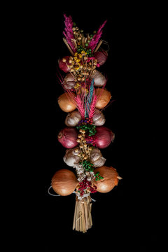 historical tie of onions and garlic with flowers and colorful grass to