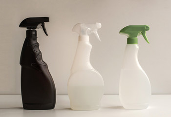 Black, white and green spray gun on a light background