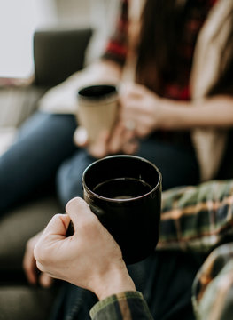 close up of two people full holding coffee cups. selective focus