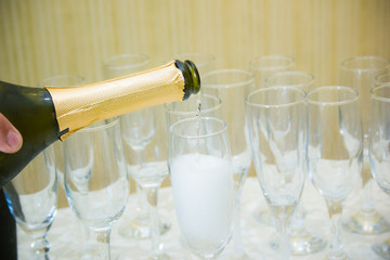 Pouring champagne into glasses

