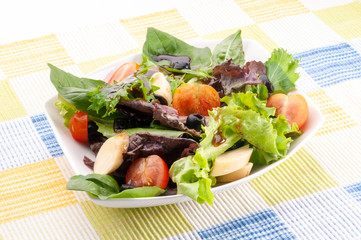 cherry tomato salad, lettuce, black olives, hearts of palm, without dressing, over a tablecloth