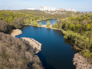 Fototapeta na wymiar Forest lake on a spring day. Aerial drone view.