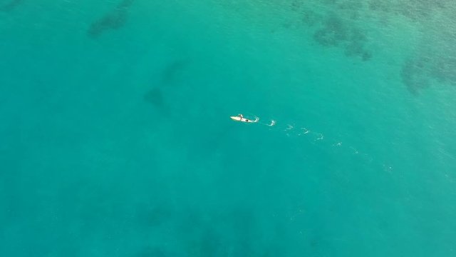 A man paddle boarding off the coast of Lahaina, Maui