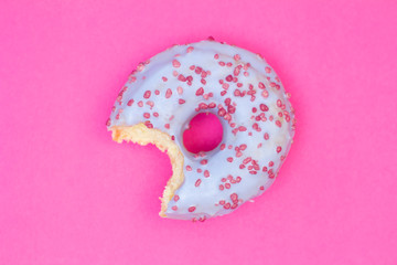 Sweet blue donut on pink background. Dessert food
