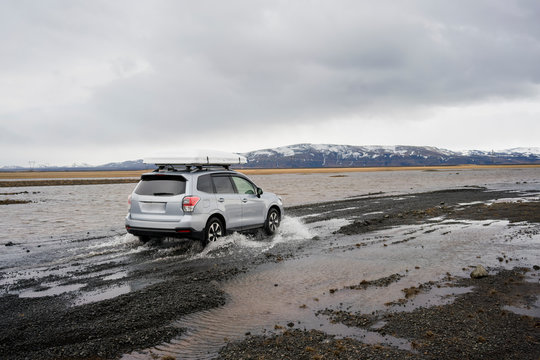 Car crossing stream in Iceland