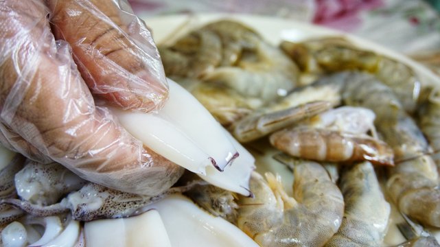 Image of hand holding seafood