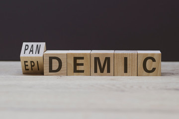 The word pandemic or epidemic on wooden cubes. Medical concept covid-19 close-up