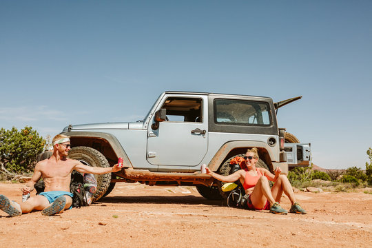 male and female hikers cheers from afar after reaching their camp