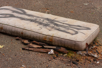 homeless worn and abandoned mattress