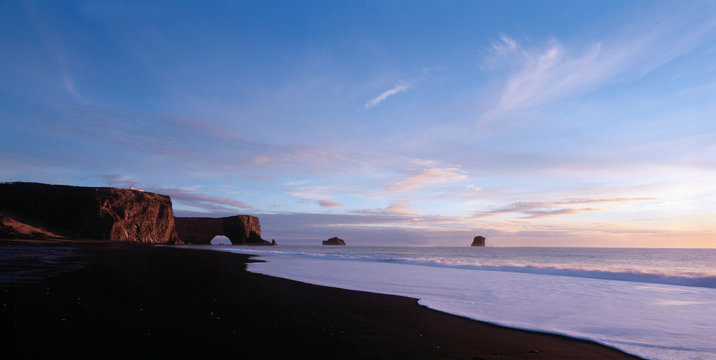 the black sand beach at the arch Dyrh&Ucirc;laey in south Iceland
